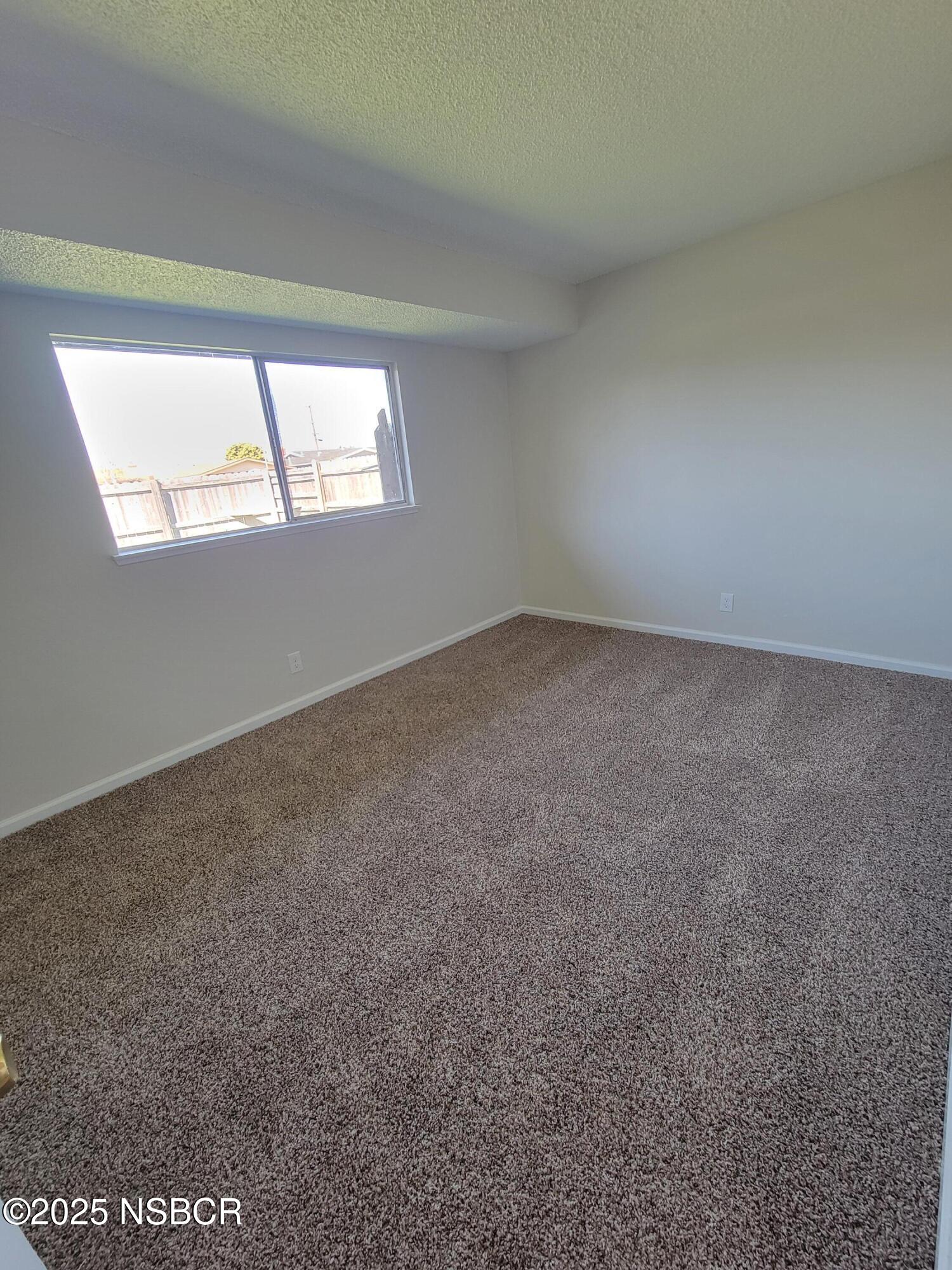 1328 West Willow Avenue Lompoc, CA 93436 - Photo 8 of 22 an empty room with windows