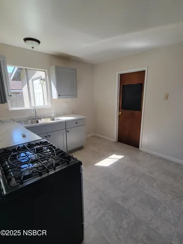 a kitchen that has a sink and a stove