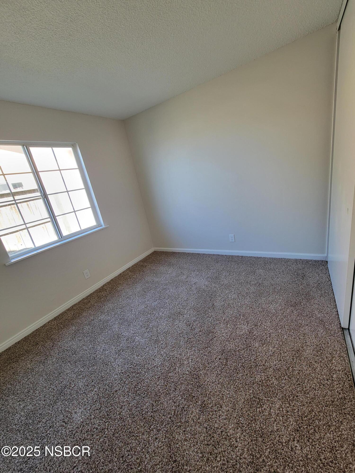 1328 West Willow Avenue Lompoc, CA 93436 - Photo 10 of 22 an empty room with windows