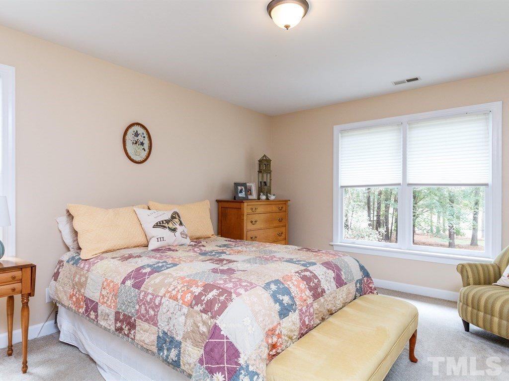 11916 Soco Court Raleigh, NC 27614 - Photo 14 of 25 a bedroom with a bed and a window