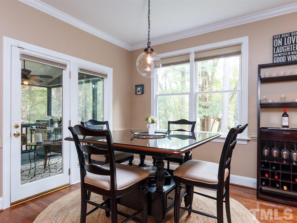 11916 Soco Court Raleigh, NC 27614 - Photo 8 of 25 a dining room with furniture a chandelier and wooden floor