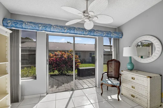 a living room with furniture a chandelier and a large window