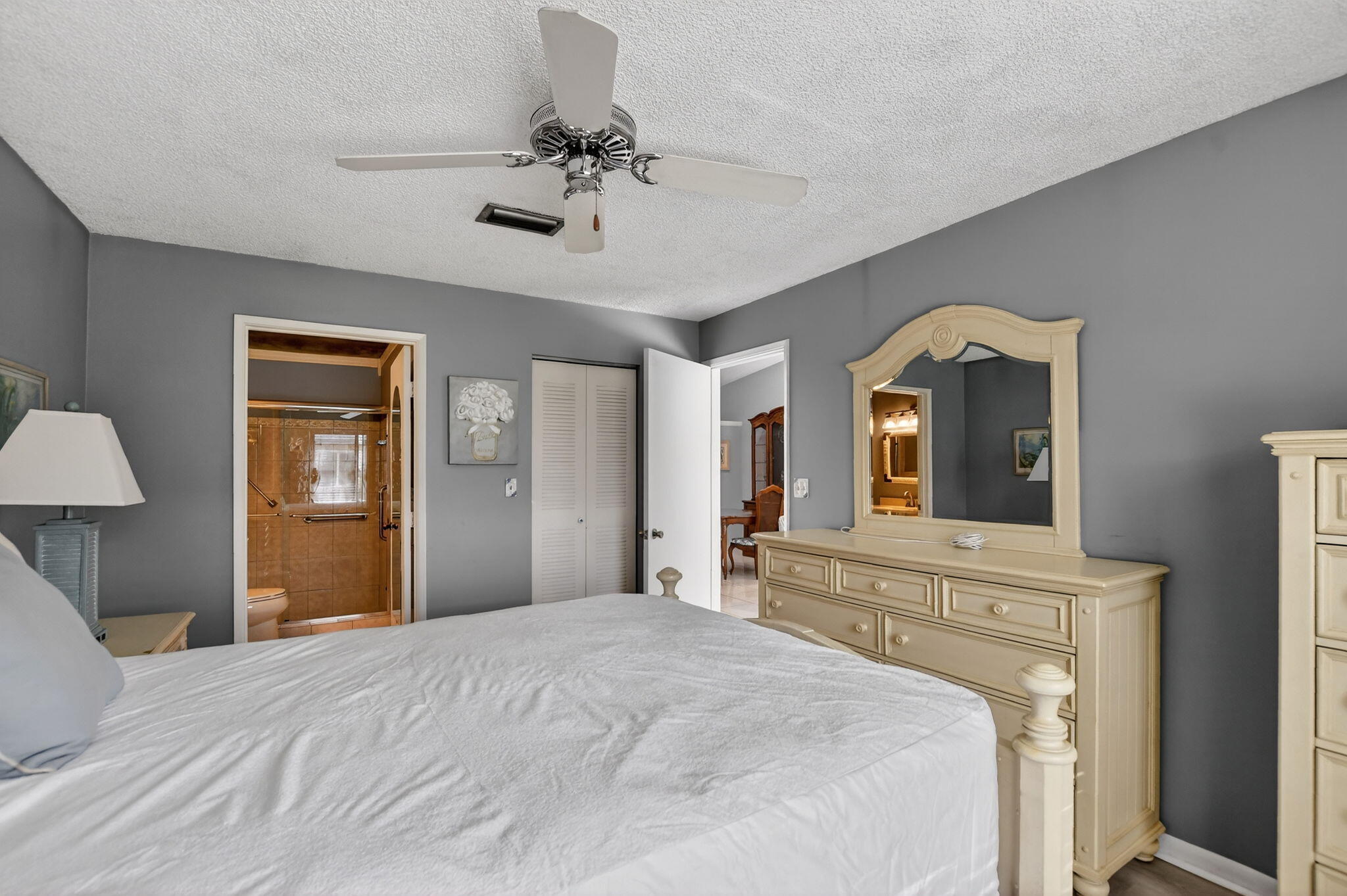 8622 Dreamside Lane Boca Raton, FL 33496 - Photo 17 of 36 a bedroom with a bed and a chandelier