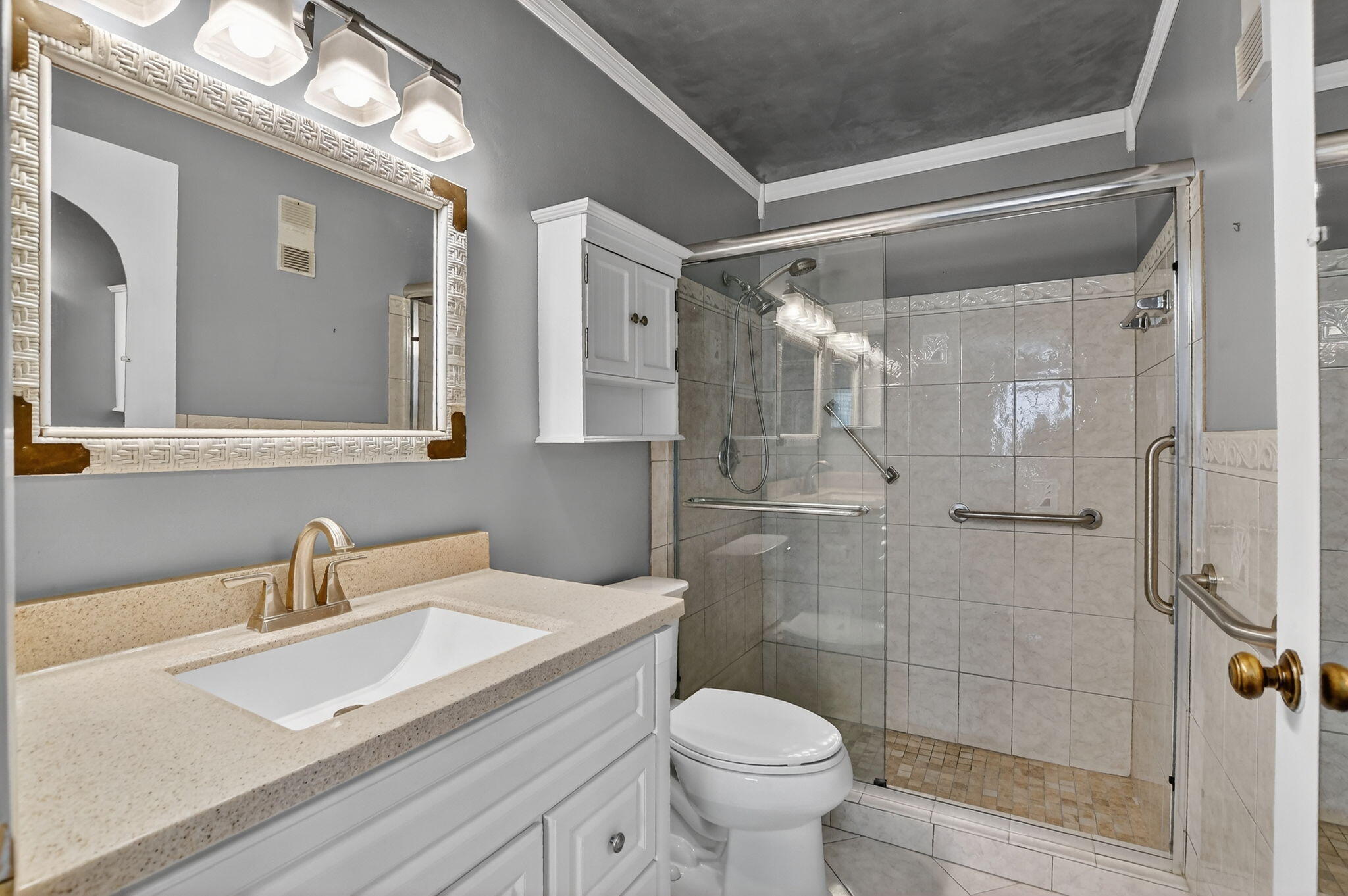 8622 Dreamside Lane Boca Raton, FL 33496 - Photo 19 of 36 a bathroom with a sink toilet a mirror and shower