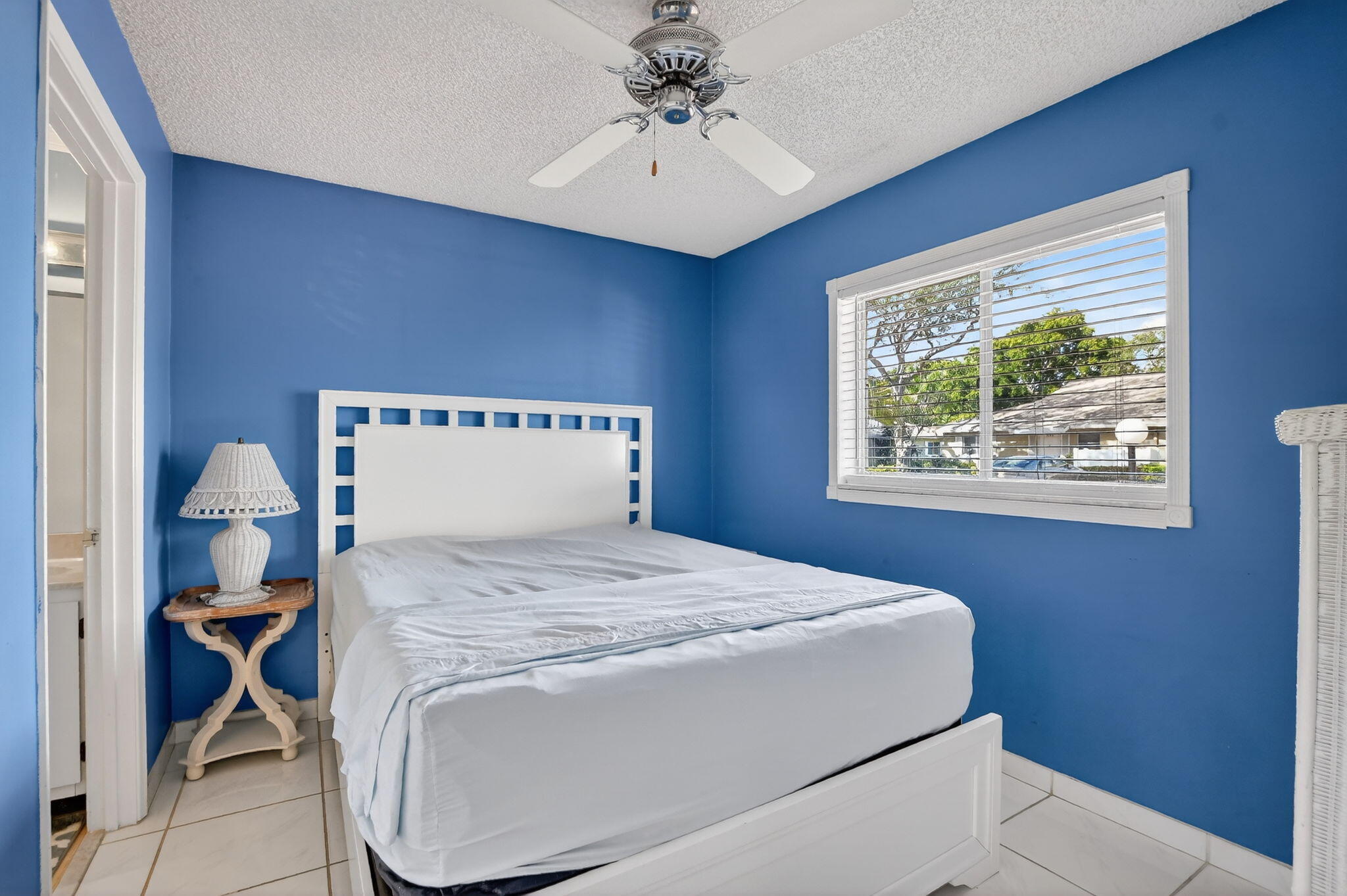 8622 Dreamside Lane Boca Raton, FL 33496 - Photo 22 of 36 a bedroom with a bed and a chandelier