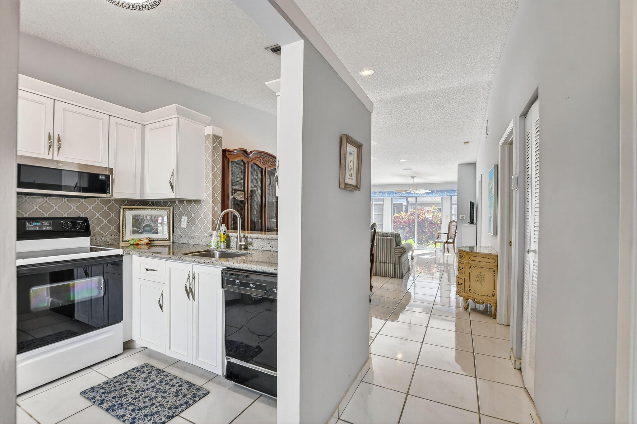 8622 Dreamside Lane Boca Raton, FL 33496 - Photo 4 of 36 a kitchen with a refrigerator and a stove top oven