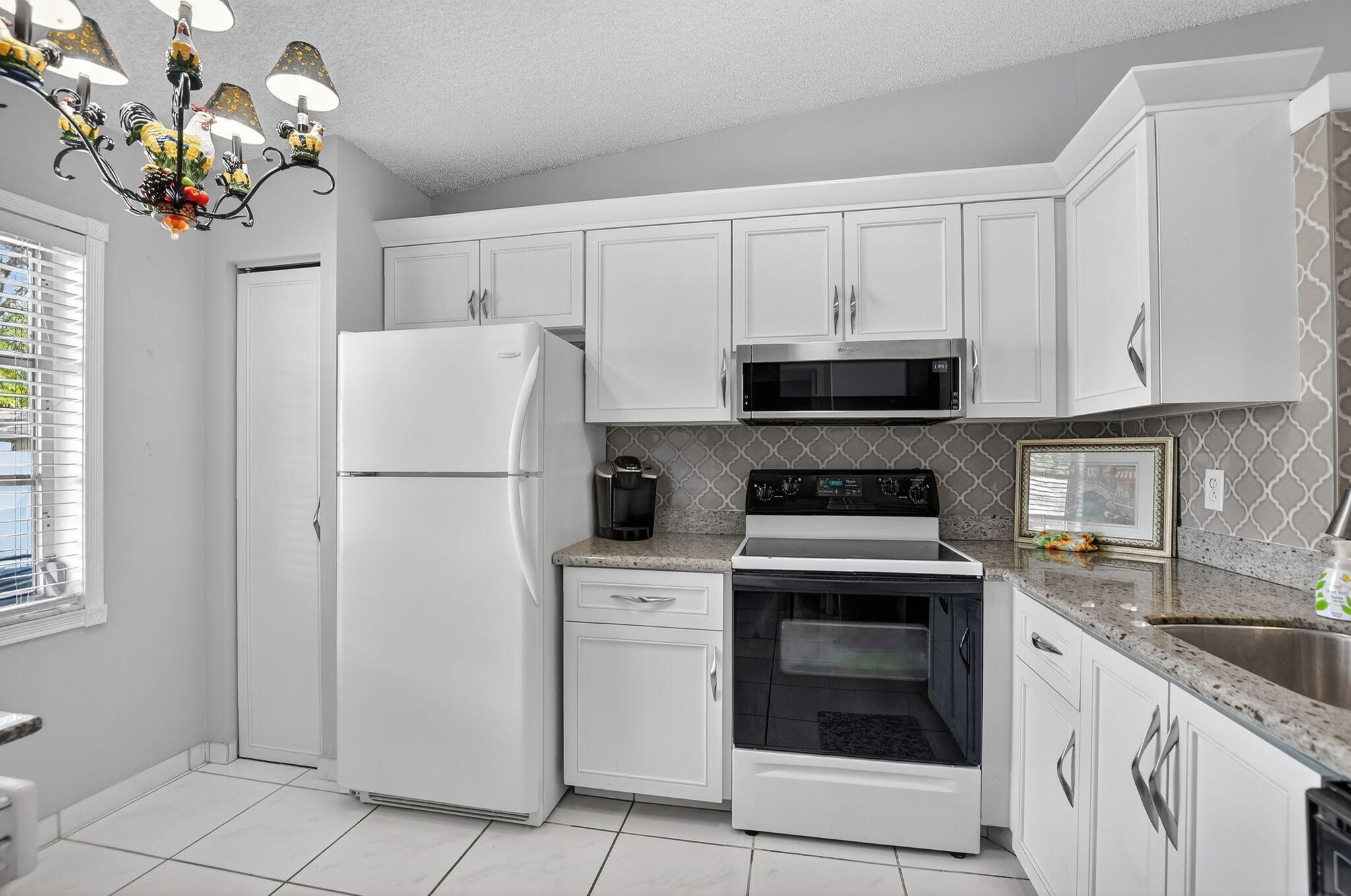 8622 Dreamside Lane Boca Raton, FL 33496 - Photo 5 of 36 a kitchen with cabinets stainless steel appliances and a potted plant