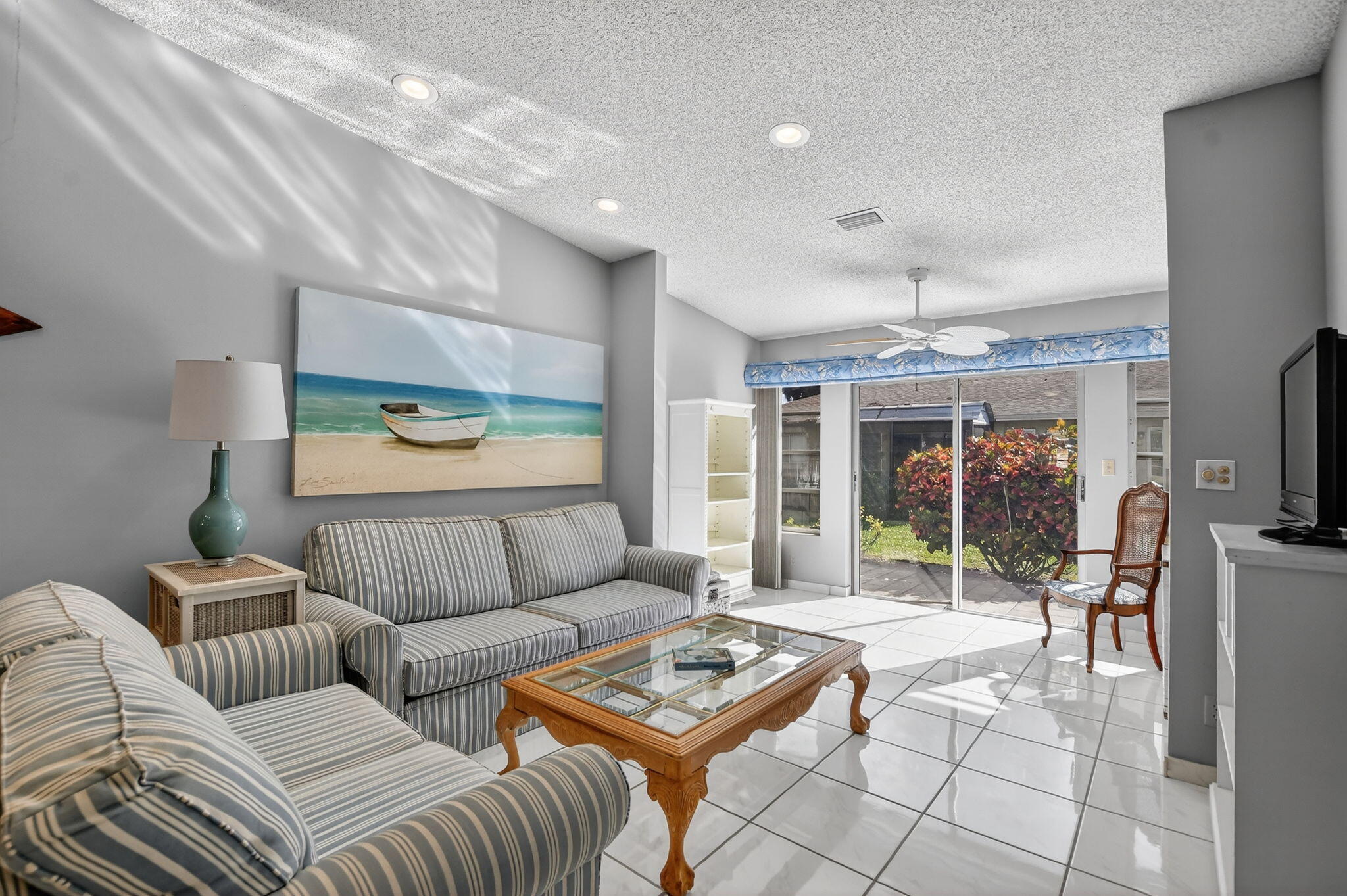 8622 Dreamside Lane Boca Raton, FL 33496 - Photo 9 of 36 a living room with furniture a flat screen tv and a large window