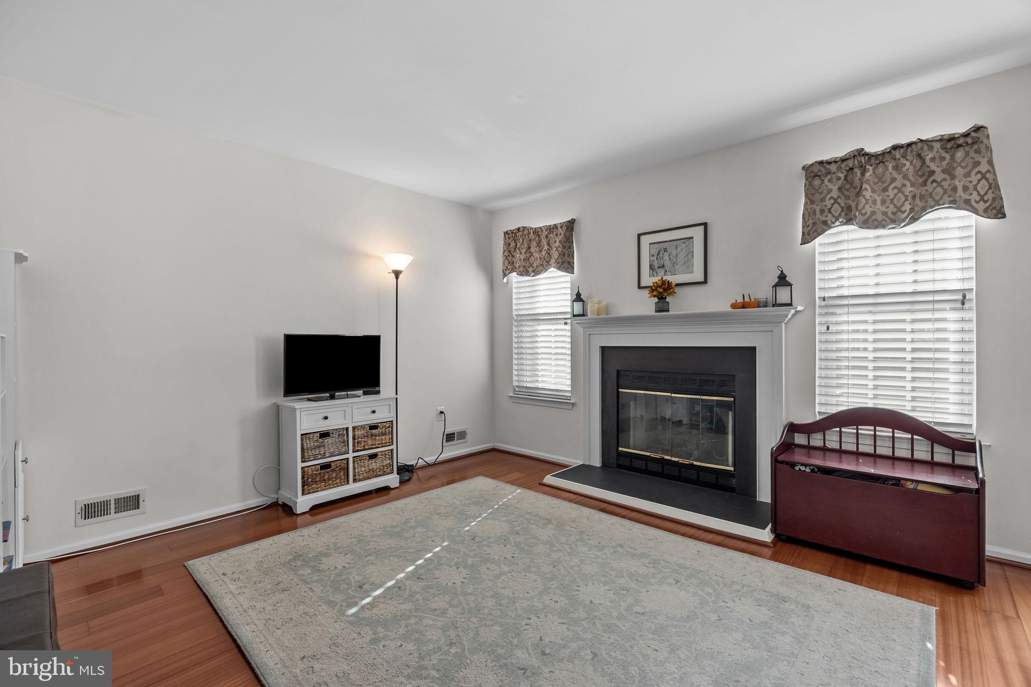 102 Broadleaf Place Newtown, PA 18940 - Photo 14 of 47 a living room with furniture a flat screen tv and a fireplace