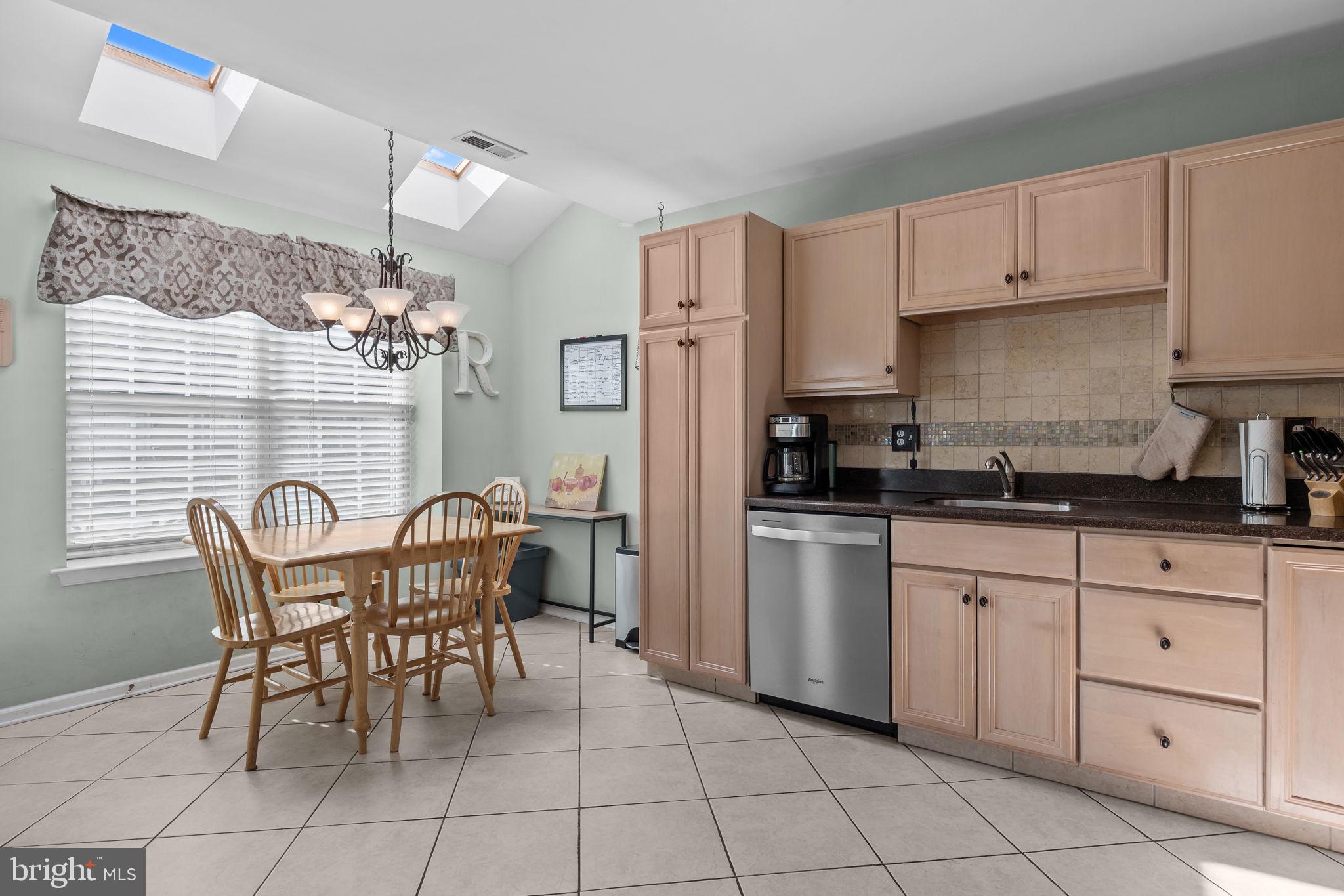 102 Broadleaf Place Newtown, PA 18940 - Photo 19 of 47 a kitchen with stainless steel appliances granite countertop a table and chairs in it