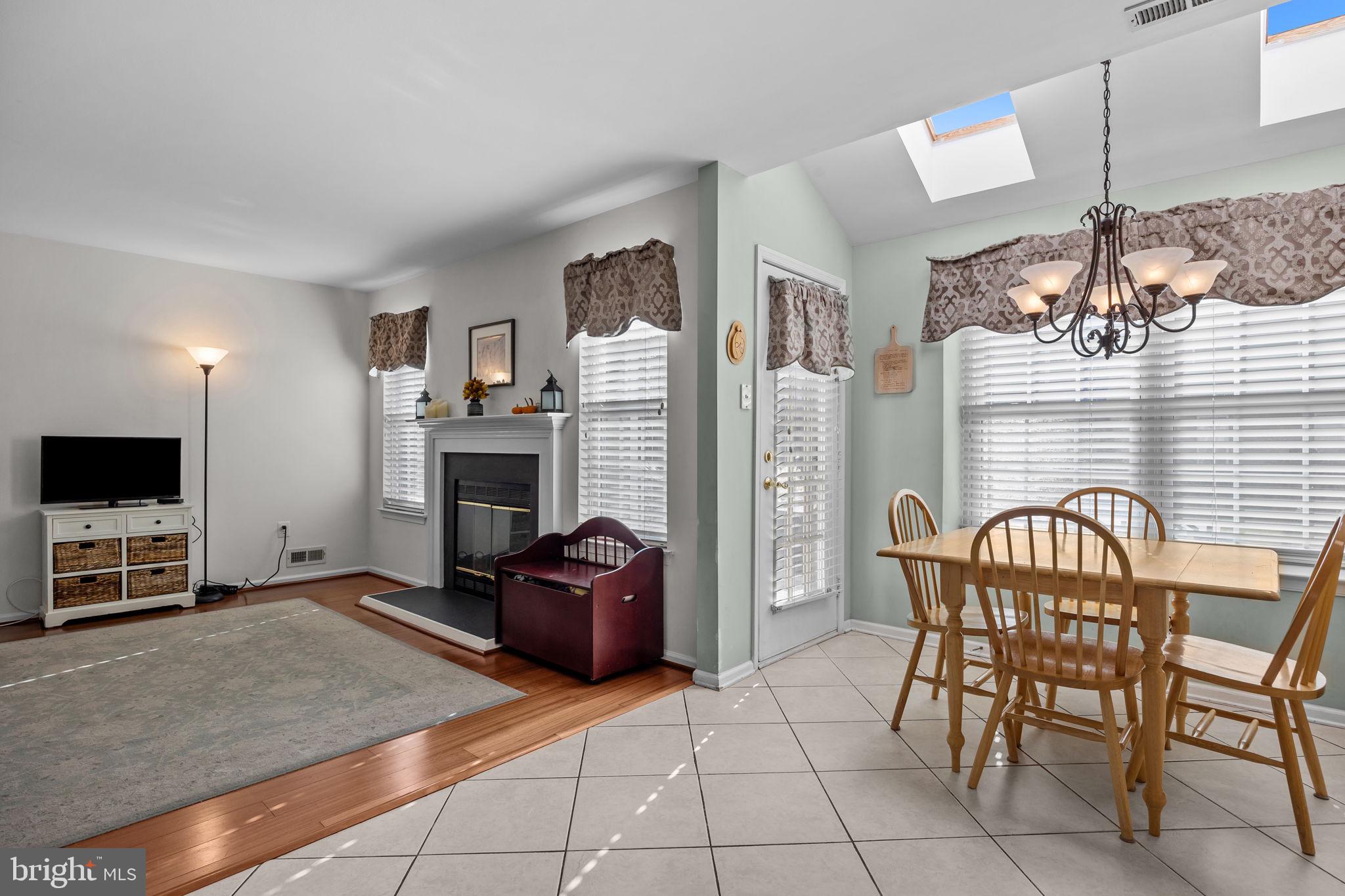 102 Broadleaf Place Newtown, PA 18940 - Photo 20 of 47 a living room with furniture a flat screen tv and kitchen view