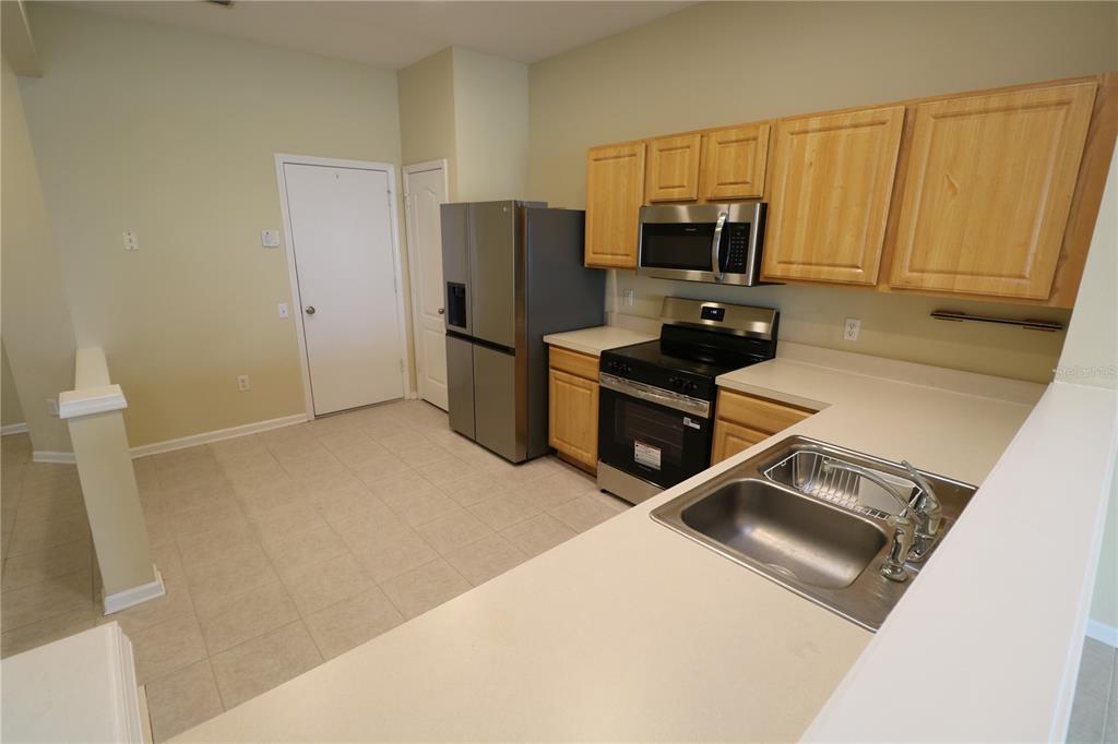 4866 Pond Ridge Drive Riverview, FL 33578 - Photo 14 of 38 a kitchen with a refrigerator sink and microwave