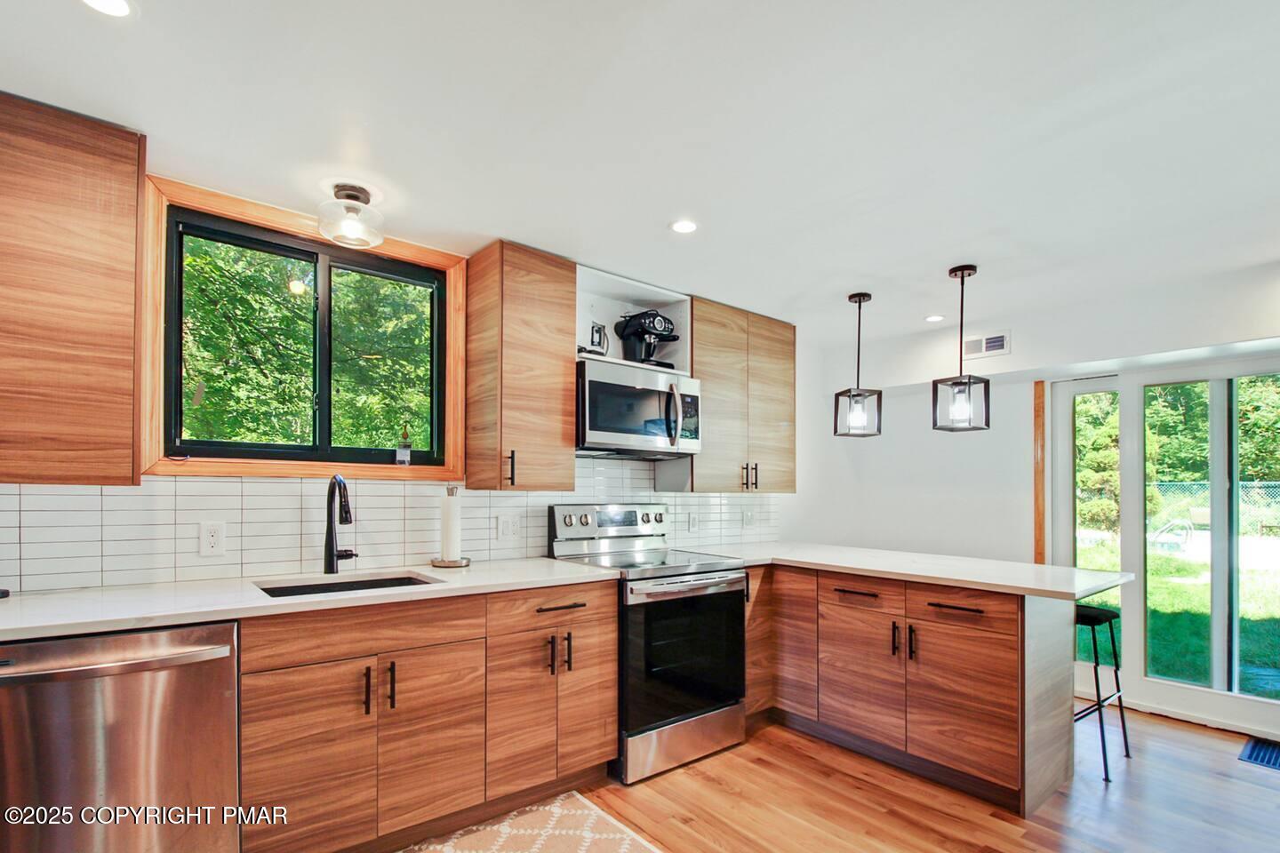 117 Bollinger Road Kunkletown, PA 18058 - Photo 14 of 25 a kitchen with stainless steel appliances granite countertop a sink stove and cabinets