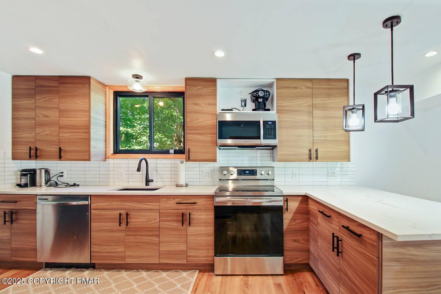 117 Bollinger Road Kunkletown, PA 18058 - Photo 15 of 25 a kitchen with stainless steel appliances granite countertop a sink stove and cabinets