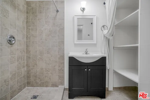 a bathroom with a sink vanity and a mirror