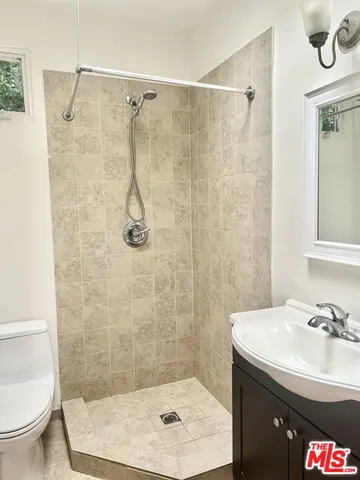 a kitchen with granite countertop a table chairs and a refrigerator
