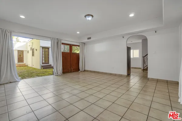 an empty room & view of a bathroom