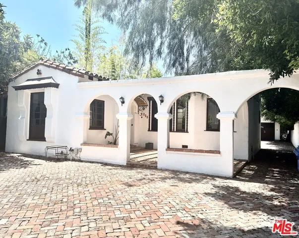 wooden floor fireplace and windows in an empty room