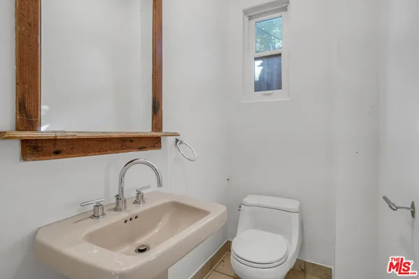 a white toilet sitting next to a bathroom sink