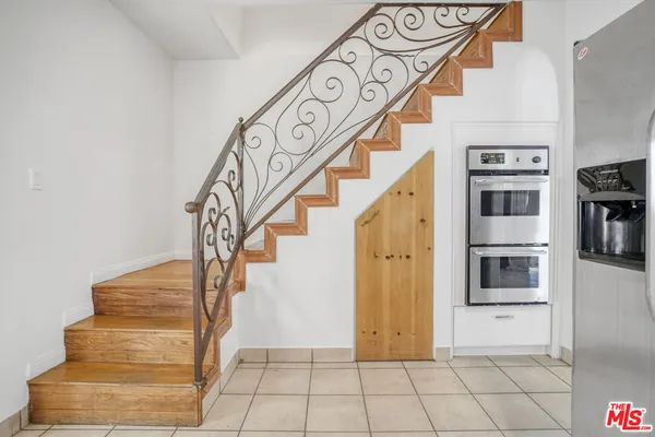 a view of an entryway with wooden floor and a front door
