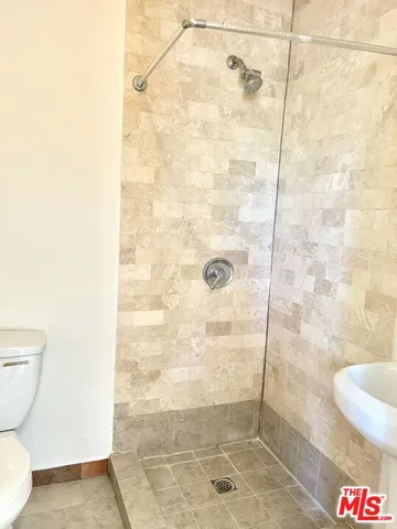 a view of a hallway with wooden floor and closet