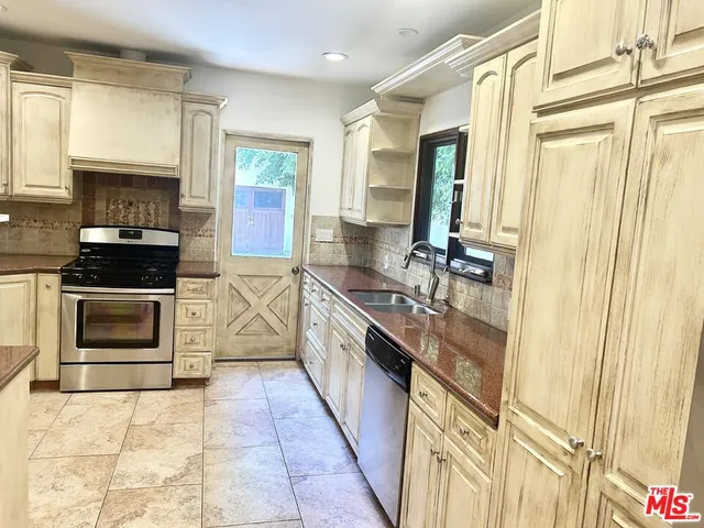 a view of an empty room with a window and hardwood floor