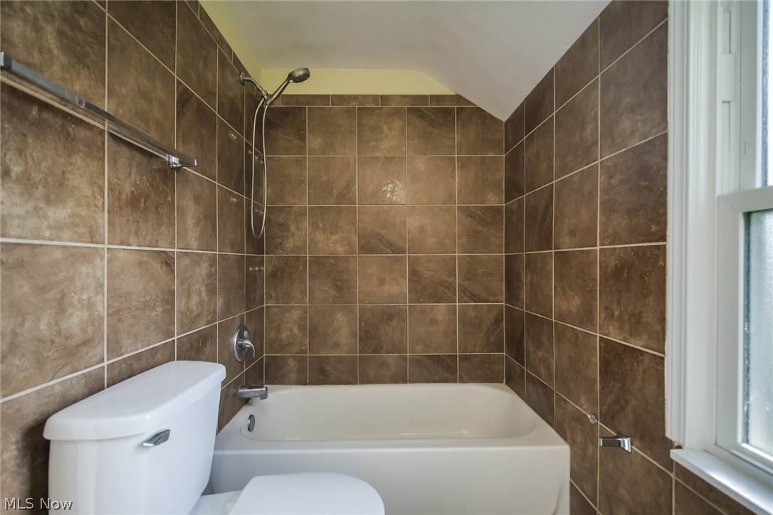736 Quilliams Road Cleveland Heights, OH 44121 - Photo 14 of 20 Bathroom with tiled shower / bath combo, toilet, and tile walls