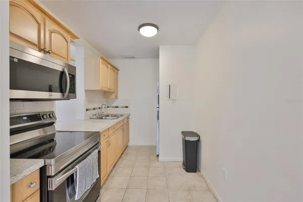 a kitchen with a sink cabinets and stainless steel appliances