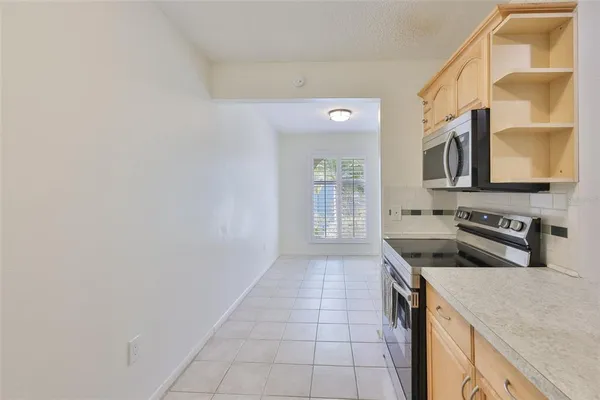 a kitchen with stainless steel appliances a sink stove and cabinets