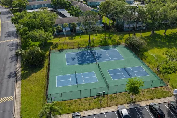 an aerial view of a house with a yard basket ball court and outdoor seating