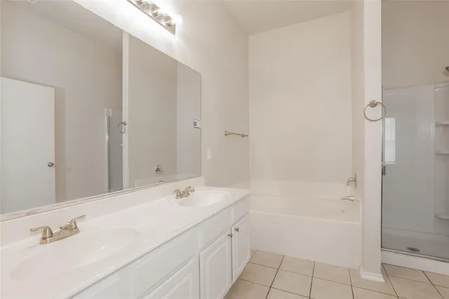 a spacious bathroom with a shower sink and mirror
