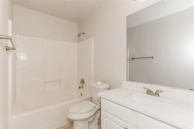 a bathroom with a sink toilet vanity and shower