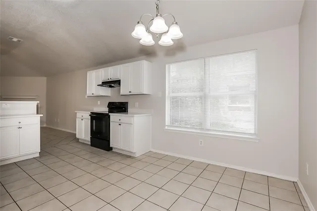 a kitchen with a stove a sink and a refrigerator