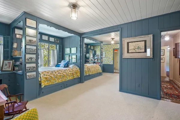 a bedroom with furniture and large windows