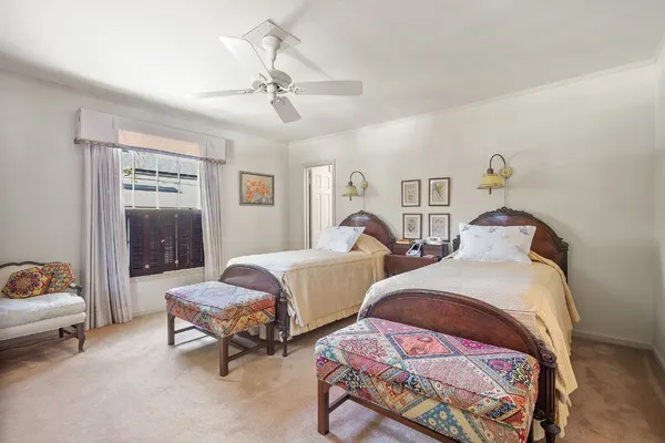 a bedroom with two beds and a window