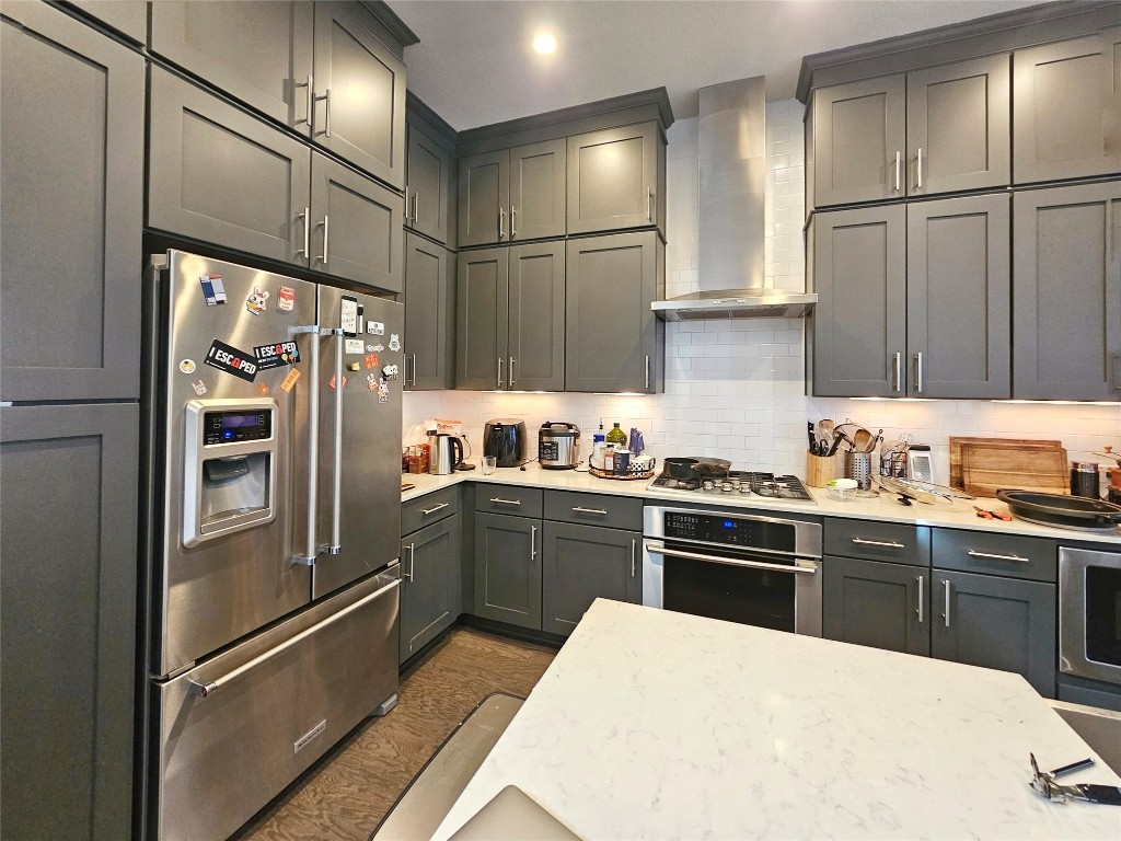 7511 Wildcat Pass Austin, TX 78757 - Photo 8 of 24 a kitchen with granite countertop stainless steel appliances and refrigerator