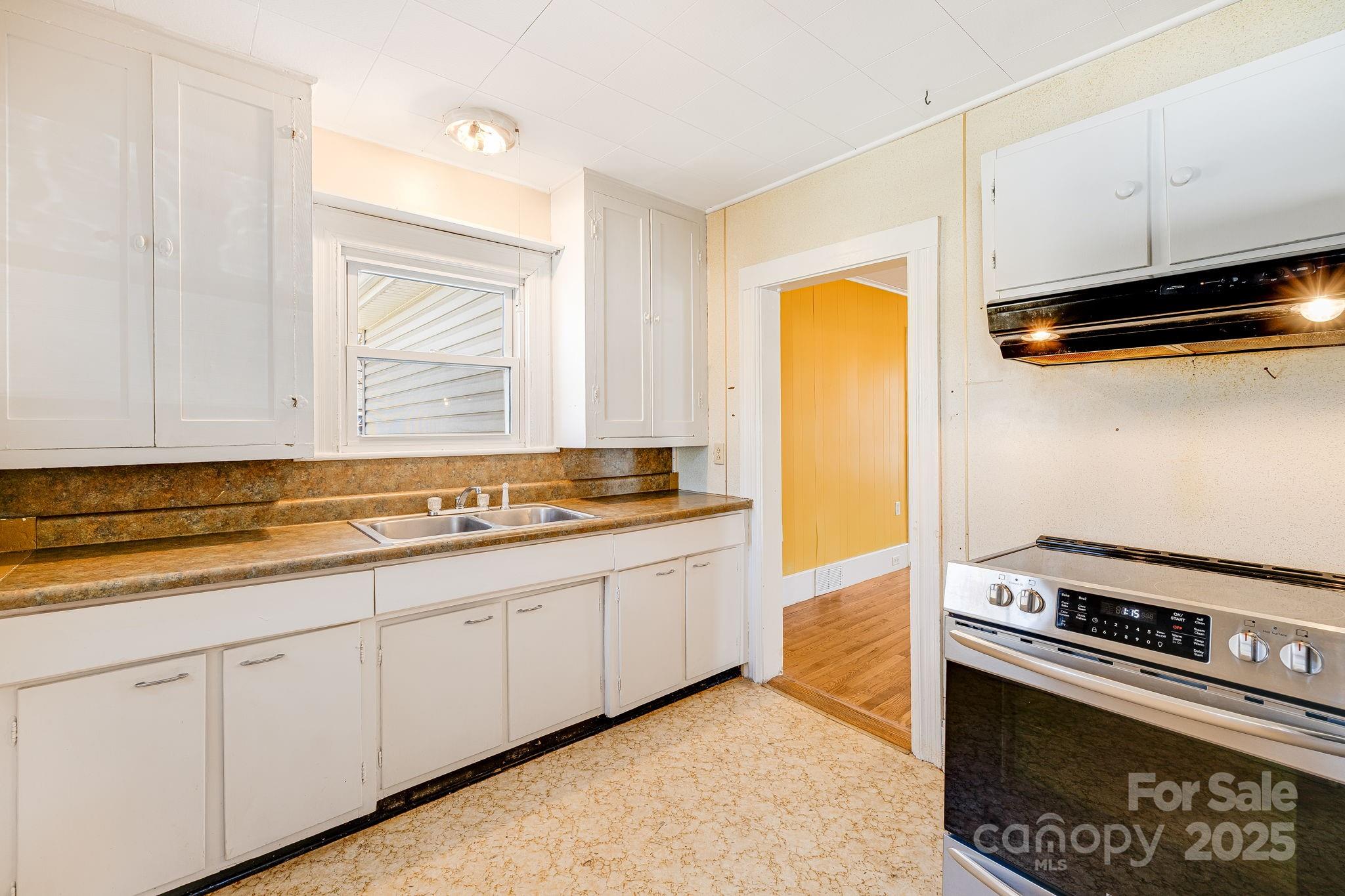 4243 Old Clyde Road Clyde, NC 28721 - Photo 11 of 37 a kitchen with stainless steel appliances granite countertop a sink and a stove