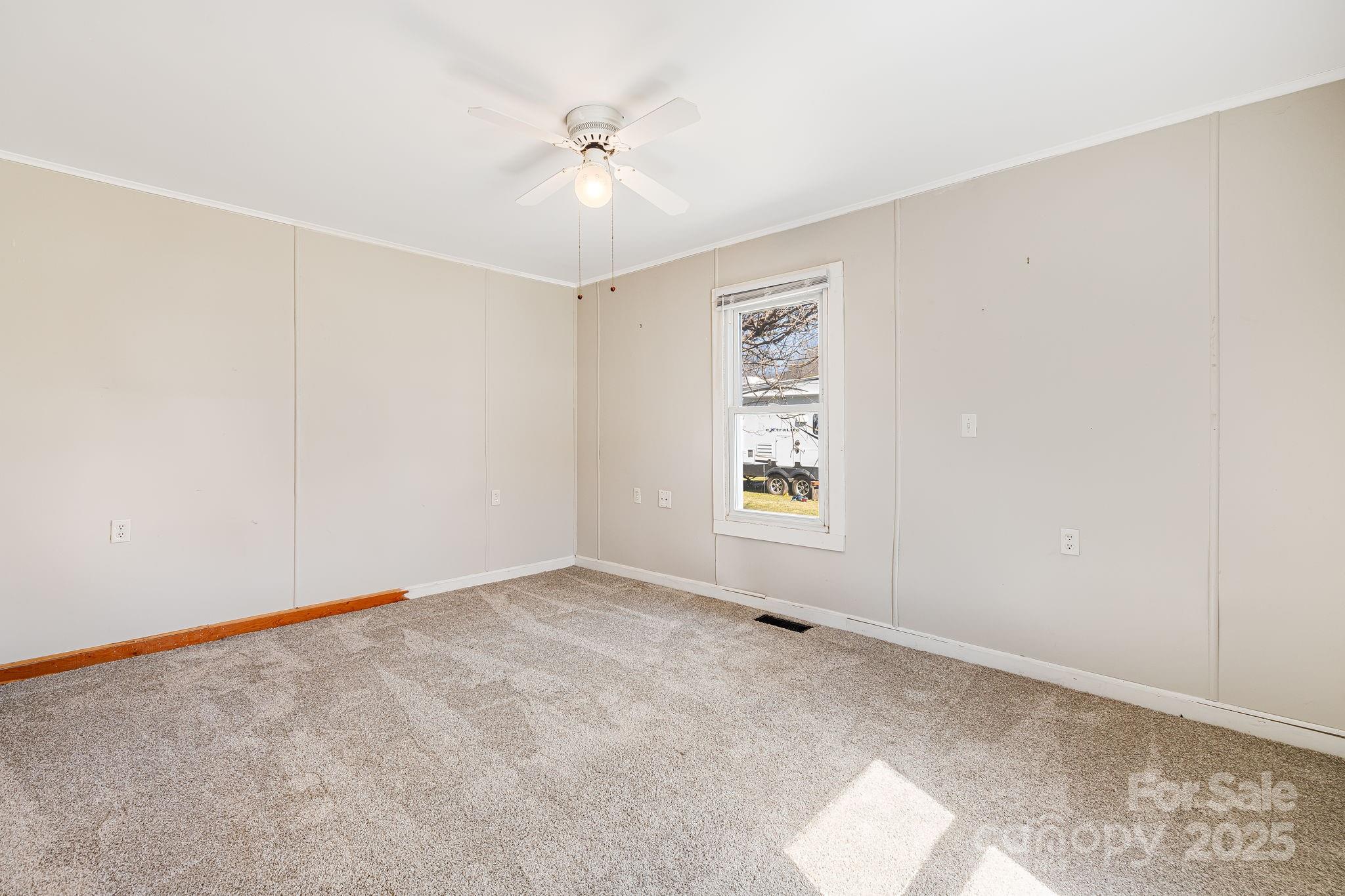 4243 Old Clyde Road Clyde, NC 28721 - Photo 14 of 37 an empty room with windows and fan