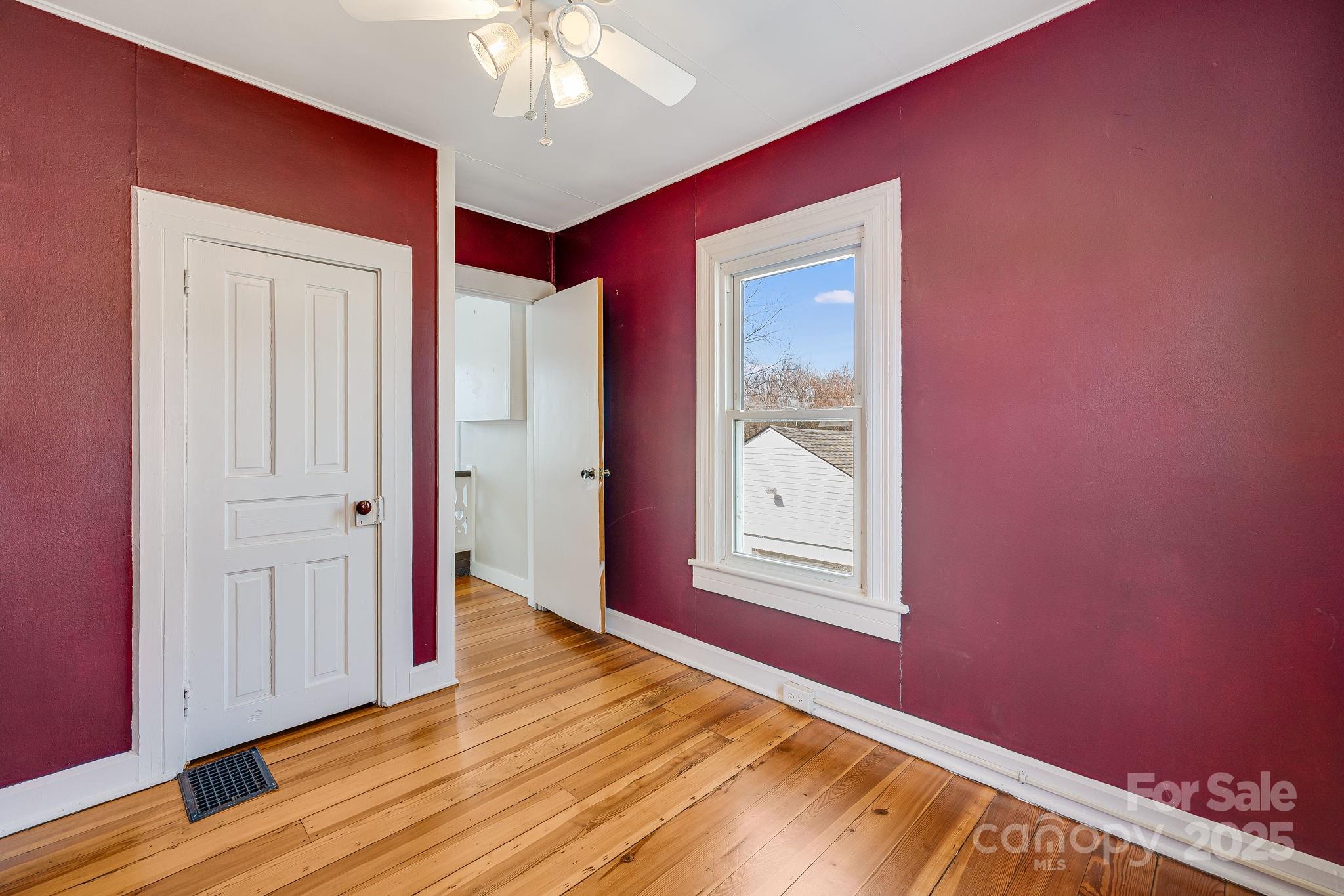 4243 Old Clyde Road Clyde, NC 28721 - Photo 19 of 37 a view of an empty room with wooden floor and a window