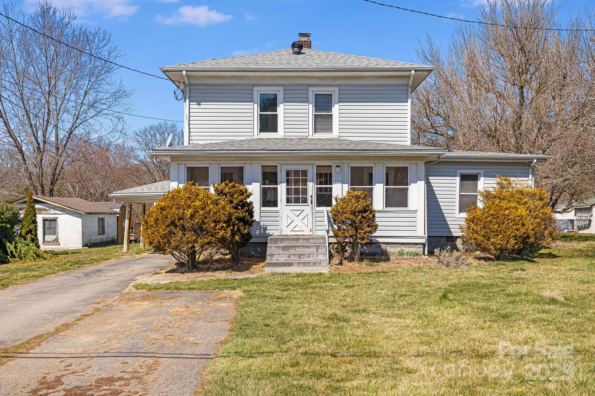 4243 Old Clyde Road Clyde, NC 28721 - Photo 2 of 37 a front view of a house with garden