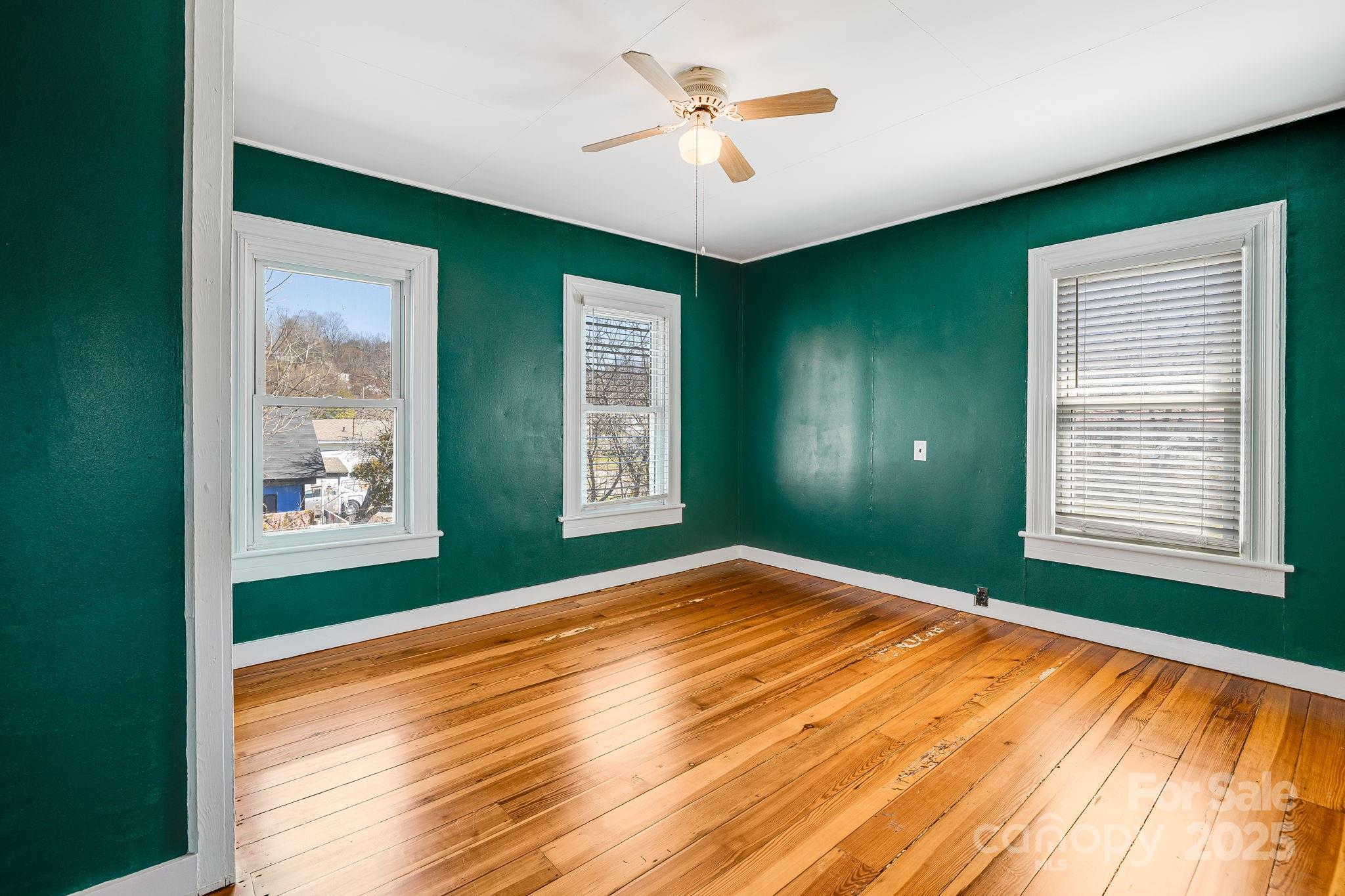 4243 Old Clyde Road Clyde, NC 28721 - Photo 22 of 37 a view of empty room with window and ceiling fan
