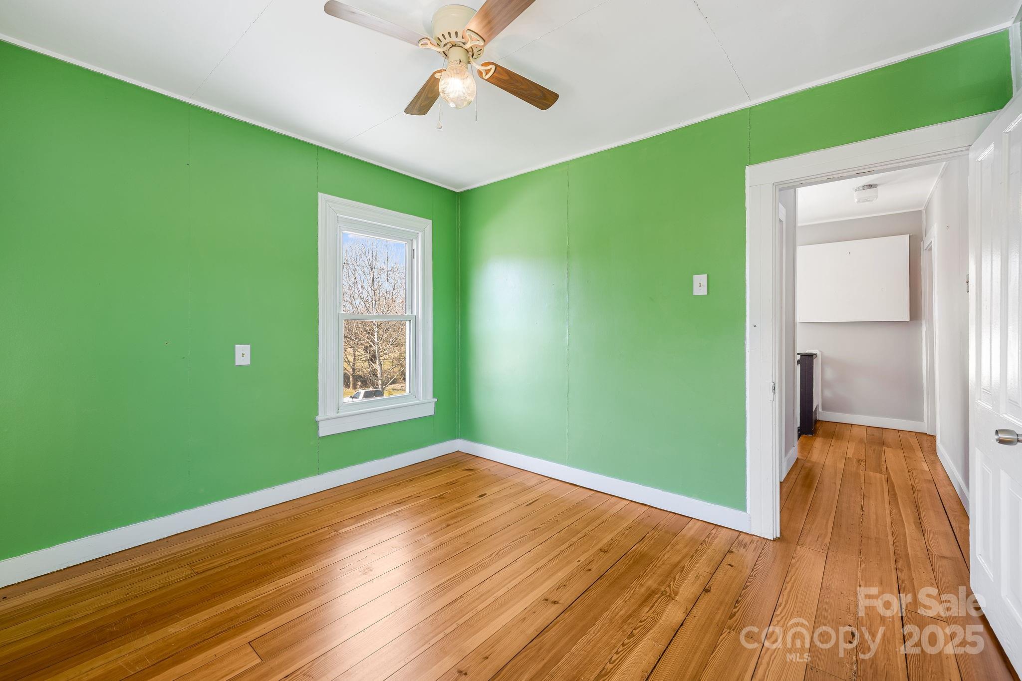 4243 Old Clyde Road Clyde, NC 28721 - Photo 24 of 37 a view of room with window and hardwood floor