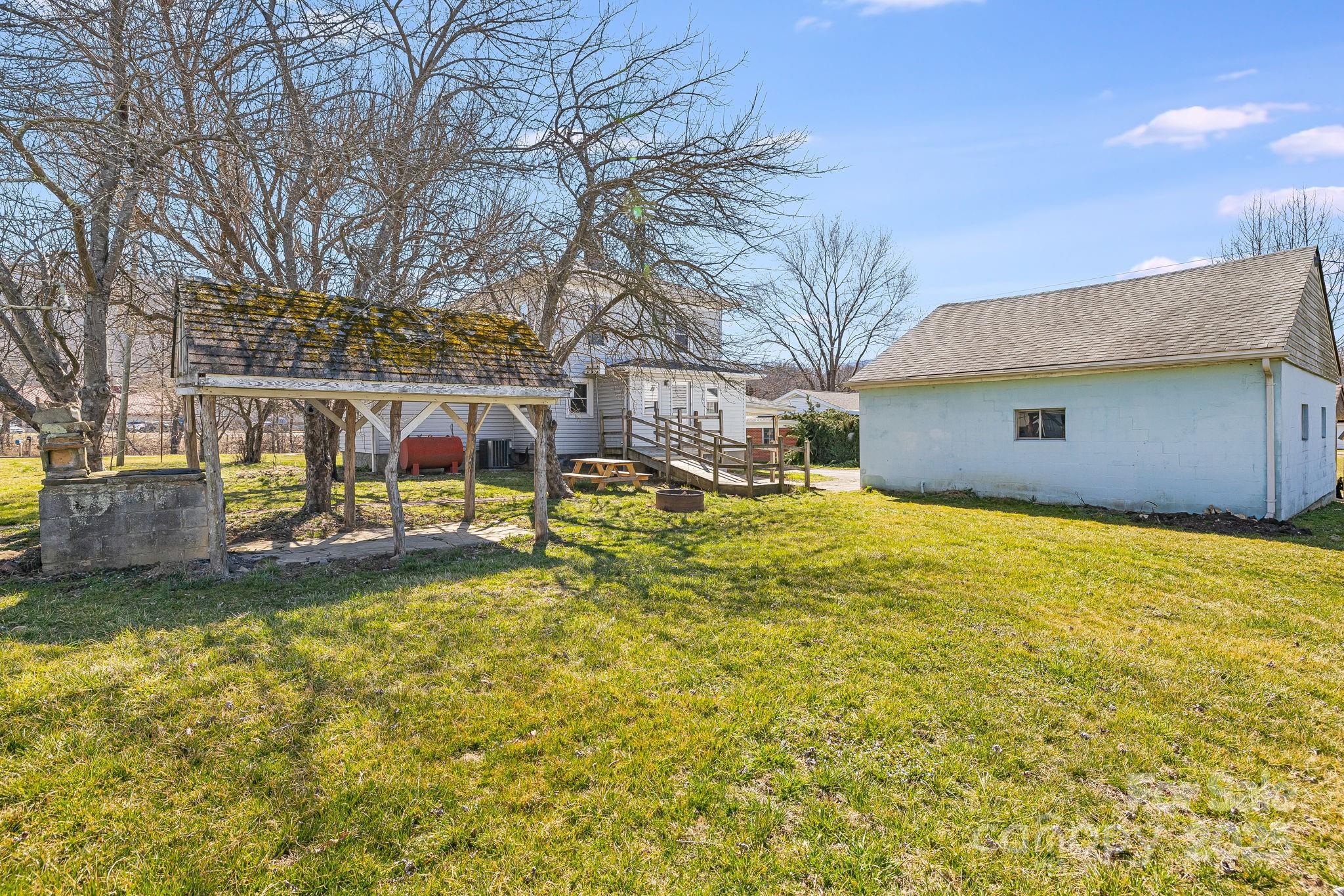 4243 Old Clyde Road Clyde, NC 28721 - Photo 33 of 37 a view of a house with a yard and sitting area