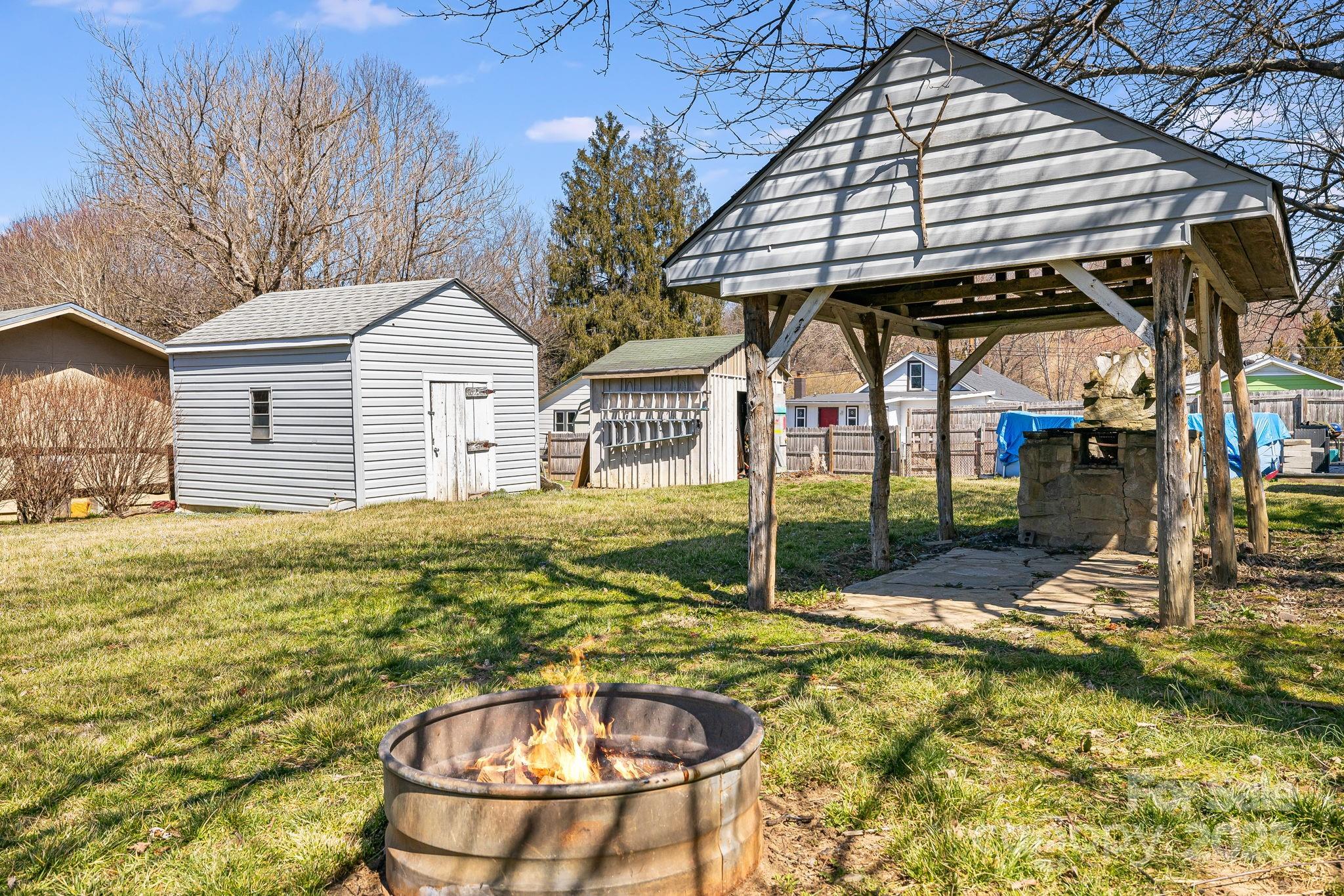4243 Old Clyde Road Clyde, NC 28721 - Photo 35 of 37 a backyard of a house with table and chairs