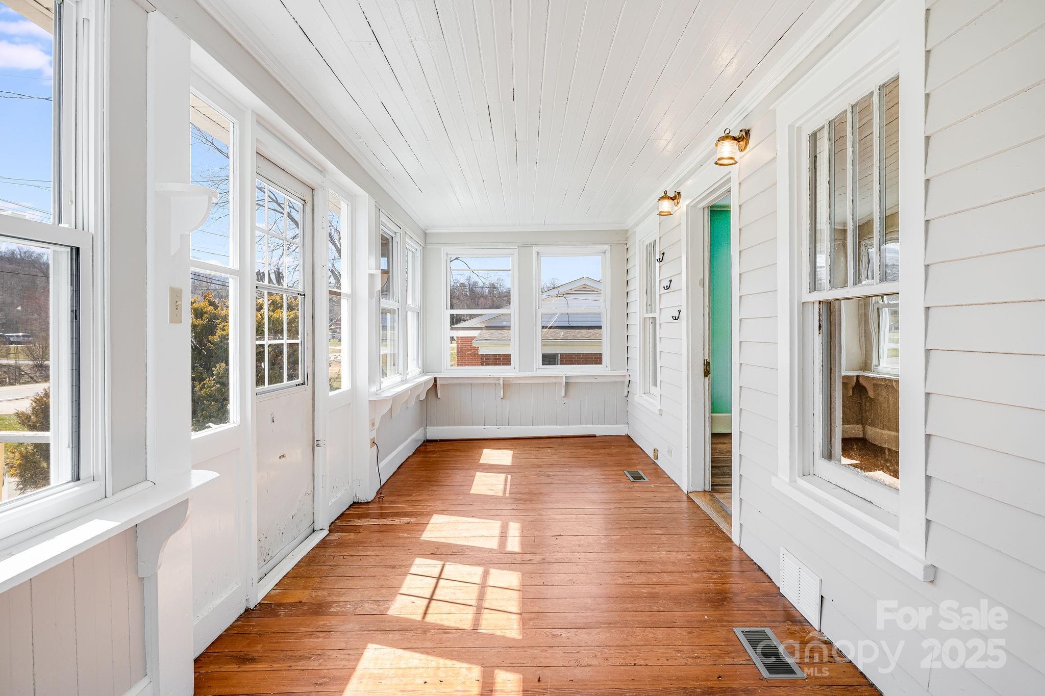 4243 Old Clyde Road Clyde, NC 28721 - Photo 4 of 37 a view of a hallway with wooden floor and windows