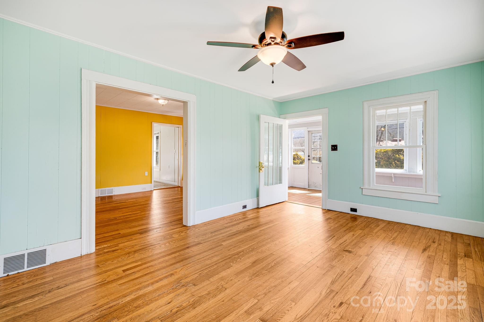 4243 Old Clyde Road Clyde, NC 28721 - Photo 6 of 37 a view of empty room with wooden floor and fan