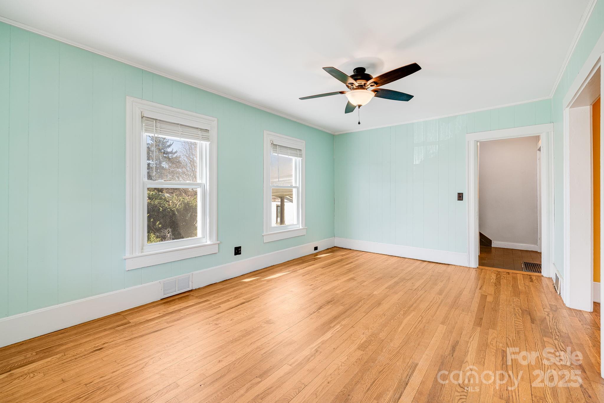 4243 Old Clyde Road Clyde, NC 28721 - Photo 7 of 37 a view of an empty room with wooden floor and a window