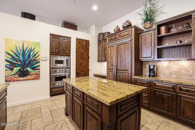 a kitchen with stainless steel appliances granite countertop a stove and a refrigerator