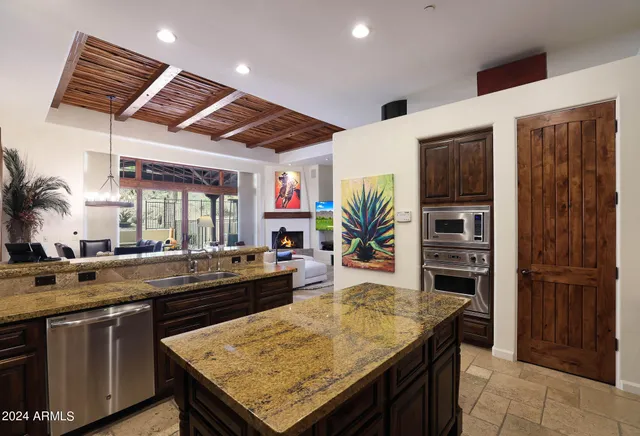 a living room with fireplace furniture and a large window