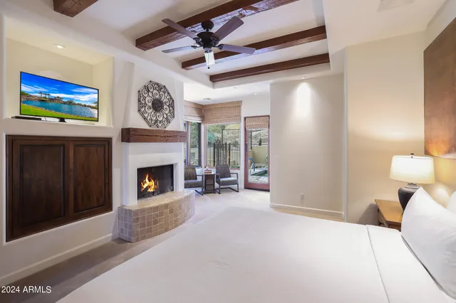 a bathroom with a tub a sink and a large mirror